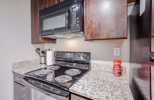Central Business District Apartment | CozySuites at the Banks gym, pool 16