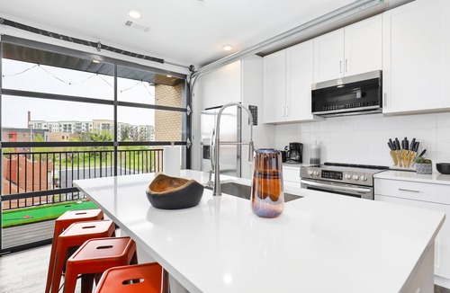Rolling Mill Hill Condo | Muse | Nashville-themed condo with oversized balcony, downtown views & putting mat
