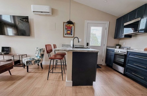 Court House Apartment | Peaceful one-bedroom mountain retreat in Floyd, Virginia featuring a full kitchen, cozy living space, private outdoor seating, and shared fire pit access just minutes from downtown Floyd.