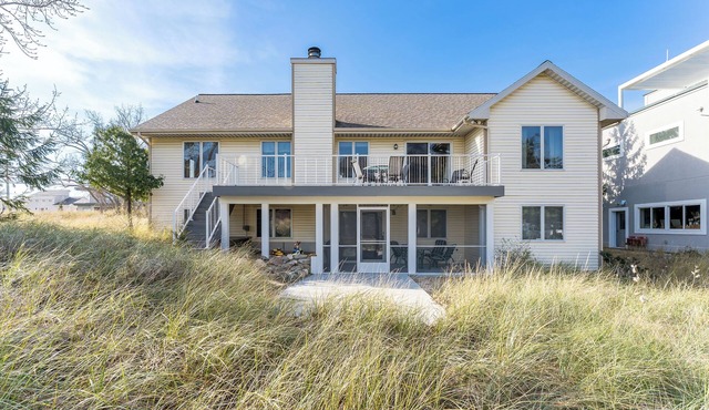 Experience lakeside luxury at Sunset Cove, a spacious 5-bedroom home in Spring Lake